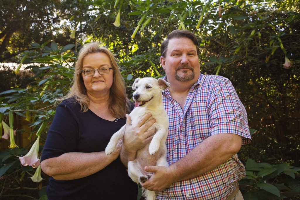 couple poses with their dog for jessica shaw photography lifestyle pet photography based in tampa